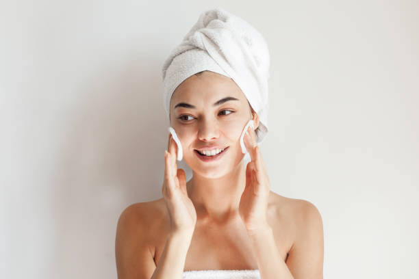 istock Smile, cream on her face, woman 1180616574