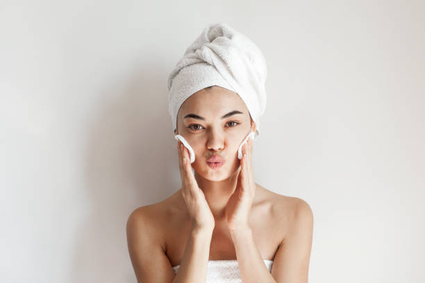 istock Smile, cream on her face, woman 1180616743