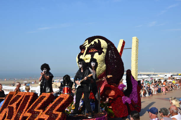 Annual summer season end. Float flower tournament. Blankenberge, West Flanders/ Belgium - August 25, 2019:: Beach festivity  flower corso, in Flemish called "Bloemencorso".Cortege of most original, beautiful riding  flower floats along beach dyke and streets. In this photo Group Kiss band Wonderland Dendermonde. kiss entertainment group stock pictures, royalty-free photos & images