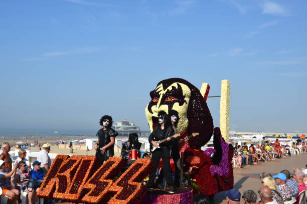 Annual summer season end. Float flower tournament. Blankenberge, West Flanders/ Belgium - August 25, 2019:: Beach festivity  flower corso, in Flemish called "Bloemencorso".Cortege of most original, beautiful riding  flower floats along beach dyke and streets. In this photo Group Kiss band Wonderland Dendermonde. kiss entertainment group stock pictures, royalty-free photos & images