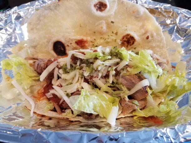 istock pork and cheese and lettuce taco in foil 1180620588