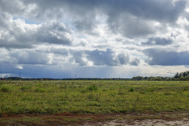 istock Rain clouds over the field. Autumn landscape. Russia 1180621902