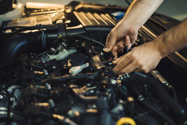 istock Close up of a mechanic examining car engine in a workshop 1180623816