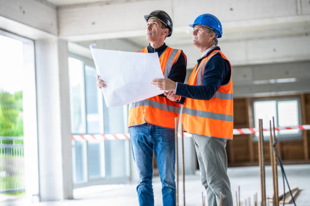 istock Investors Looking At Blueprints And Examining The Construction Site 1180627360