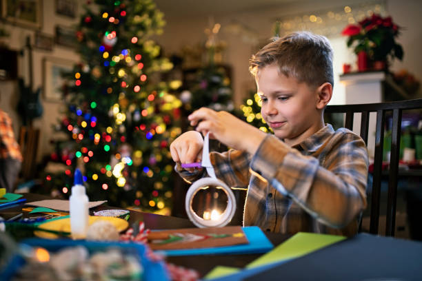istock Little boy crafting Christmas card 1180627460