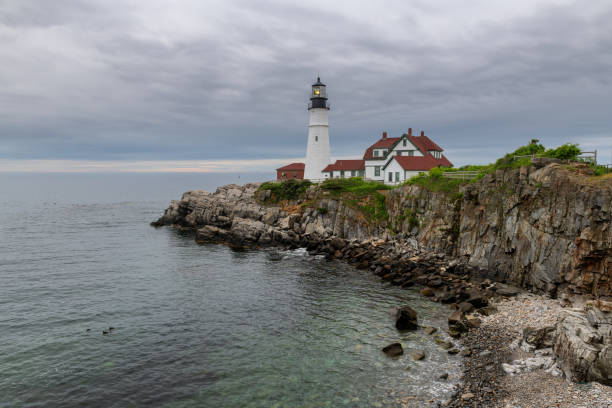 Dramatic sky over Portland Head Lighthouse at sunrise, Maine, USA