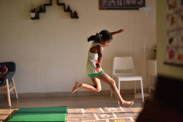 istock Girl displaying her athletics skills at home 1180629542