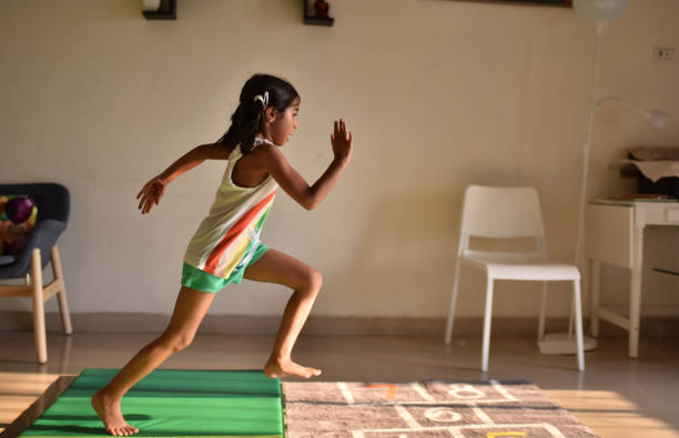 Girl displaying her athletics skills at home