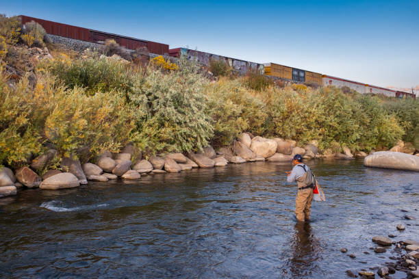 istock Euro Nymphing Fisherman With a Train Behind. 1180631912