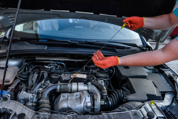 istock Human hands with oil level meter against car engine 1180636745