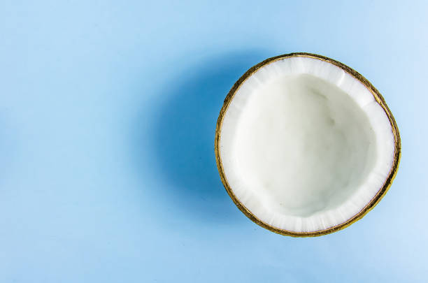 istock split coconut lies against a blue background 1180636812