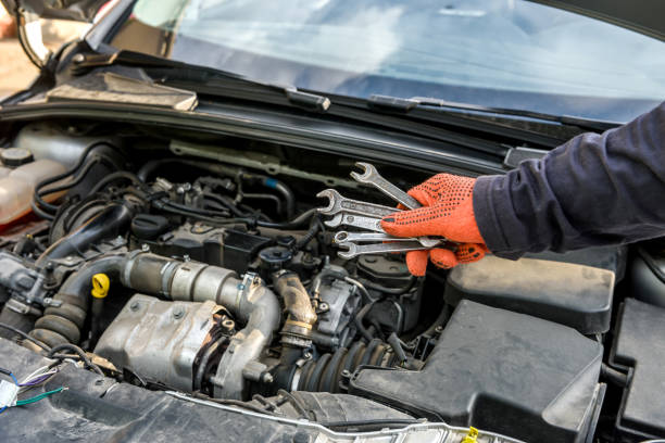 istock Male hand with steel wrenches on car engine 1180636977