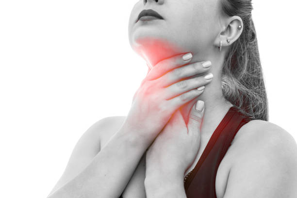 istock Woman touching her throat isolated on white 1180637762