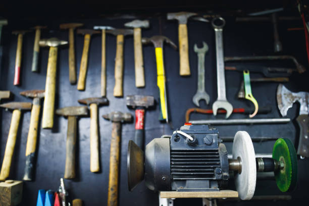 istock grinding machine in old garage, wall with rusty hammers background 1180638133