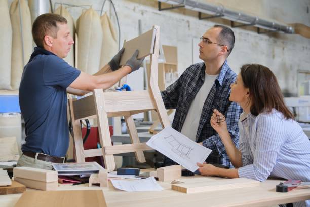 istock Group of working designers in carpentry workshop 1180639151