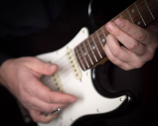 istock Male hands playing on electric guitar, close up, selected focus 1180639464
