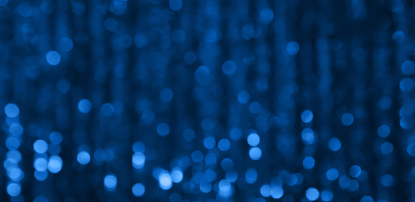 Beautiful Blue Festive abstract Background with bokeh lights. Holiday christmas Background With Copy Space. Wide Angle Texture for design to christmas, party, birthday