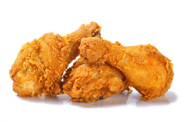 istock Fried yellow crispy spicy chicken legs on white background 1180645451