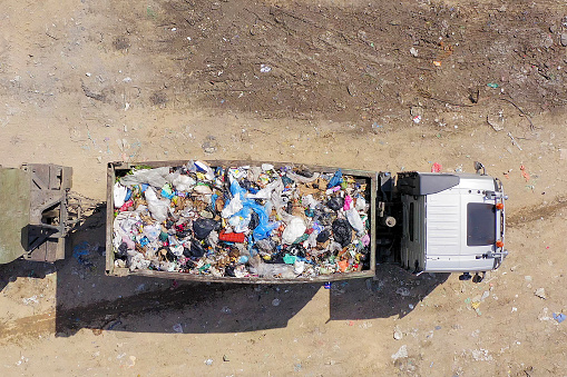 Loaded Garbage Truck at a Municipal landfill, Top down aerial image.