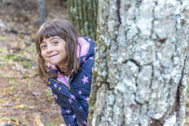 Little girl running whit hands raised in nature