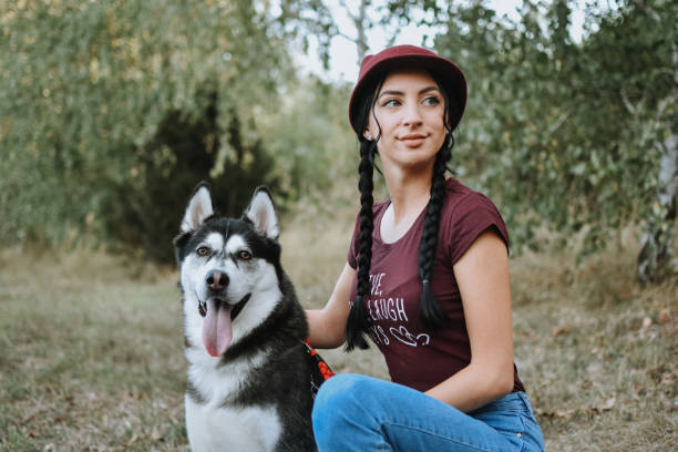 istock Young woman with dog 1180659116