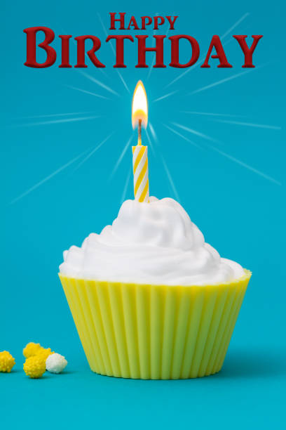 istock Happy Birthday Cupcake with burning candle on a blue background 1180661370