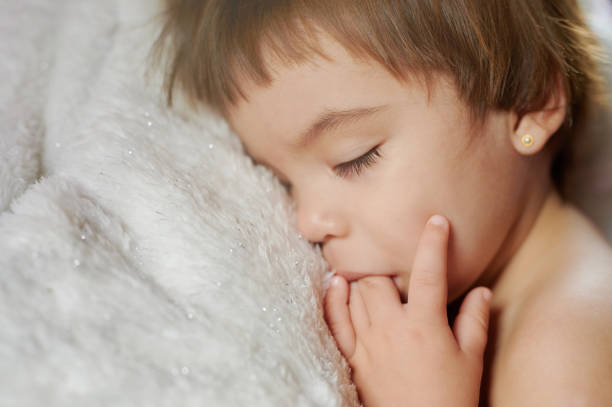Photo of child sleeping on bedroom.