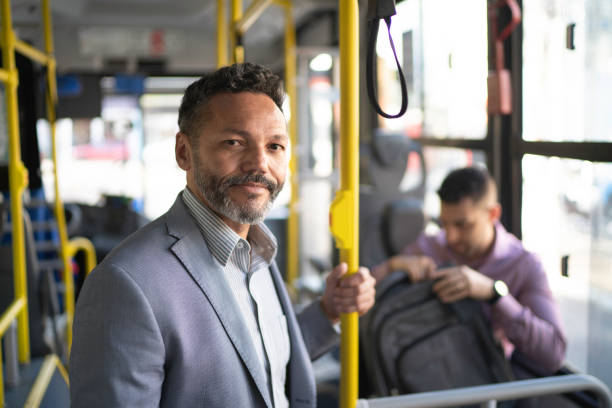istock Portrait of man looking at camera on a bus 1180662913