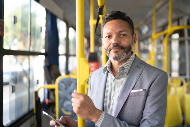 ritratto dell'uomo che guarda la macchina fotografica su un autobus - bus transportation indoors people foto e immagini stock