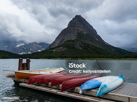 istock Canoes On Dock Below Grinnell Point 1180664183