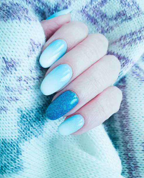 istock female hand beautiful manicure sweater 1180667270