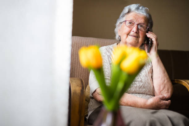 istock Senior woman talking on smart phone at home. 1180667549