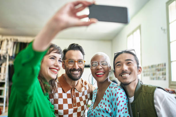 istock Male and Female Design Team Posing for Selfie in Studio 1180668412
