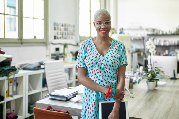 istock Smiling African Female Fashion Designer in Work Studio 1180668424