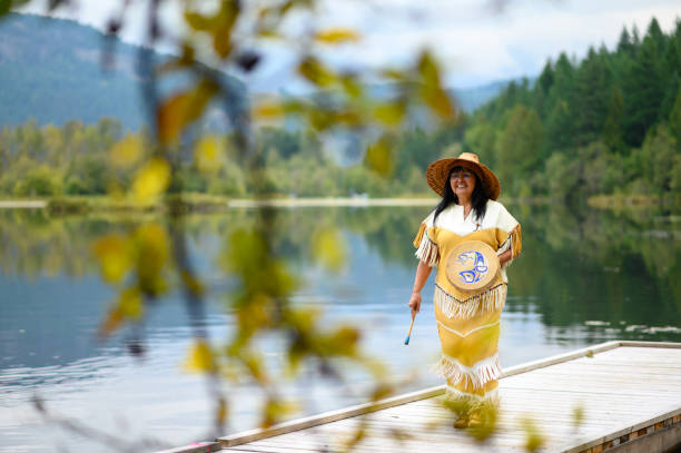 First Nations woman performing a welcome song First Nations woman performing a traditional welcome song. Traditional Canadian culture. Native American culture. canadian culture photos stock pictures, royalty-free photos & images