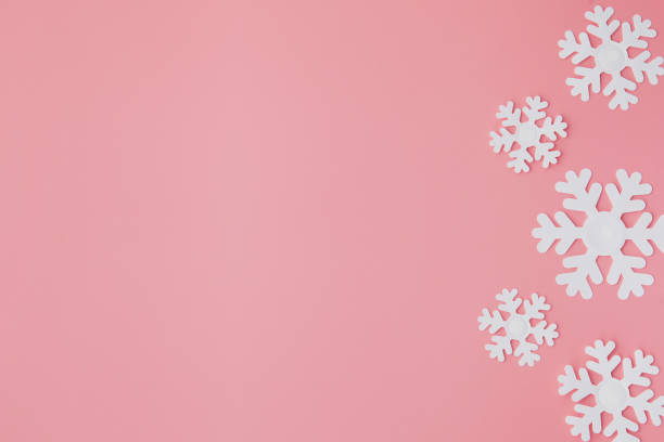 istock Winter pattern made of snowflakes and on pink background. Christmas concept. Flat lay. Copy space for your text 1180685849