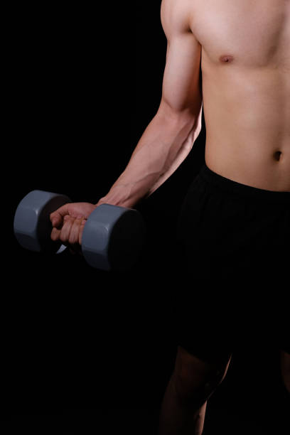 istock athletic muscular bodybuilder man with naked torso six pack abs working out with dumbbell. fitness  exercise concept 1180687752