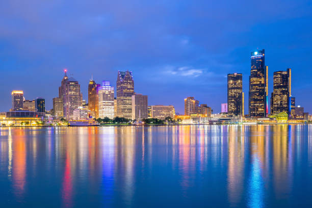 Detroit skyline in Michigan, USA at sunset Detroit skyline in Michigan, USA at sunset shot from Windsor, Ontario Canada detroit michigan stock pictures, royalty-free photos & images