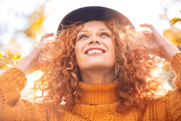 Young adult woman looking up and smiling wide stock photo