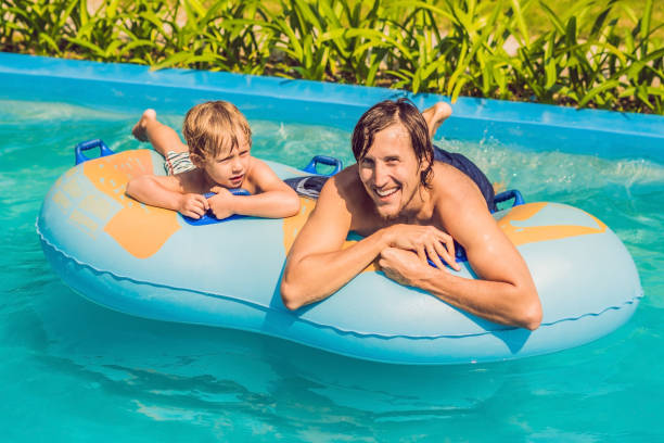 istock Father and son have fun at the water park 1180692665