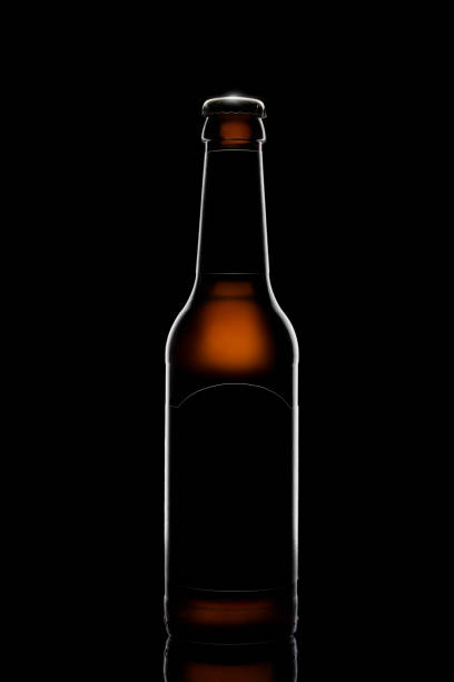 istock Silhouette of beer bottle on black background 1180694504