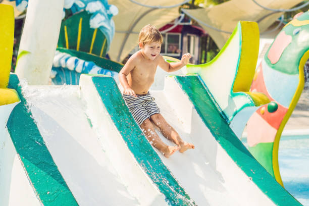 istock Boy is having fun in the water park 1180695330
