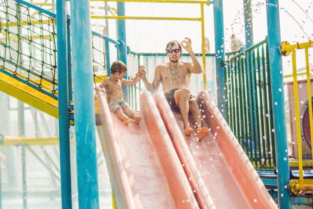istock Father and son have fun at the water park 1180695350