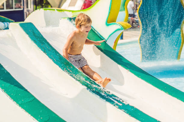 istock Boy is having fun in the water park 1180695365