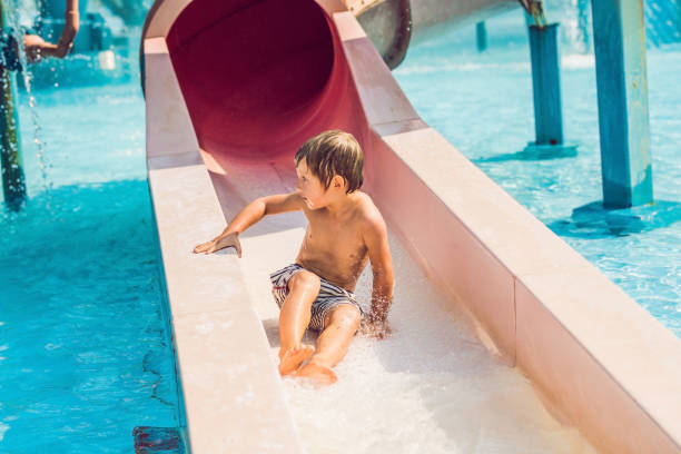 istock Boy is having fun in the water park 1180695378