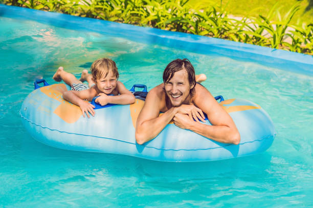 istock Father and son have fun at the water park 1180695414