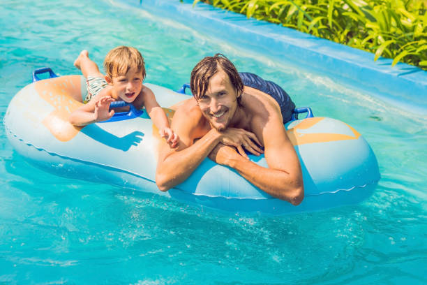 istock Father and son have fun at the water park 1180695432
