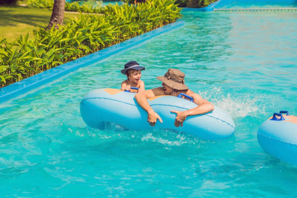 istock Father and son have fun at the water park 1180695458