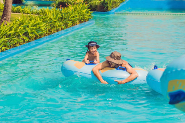 istock Father and son have fun at the water park 1180695462