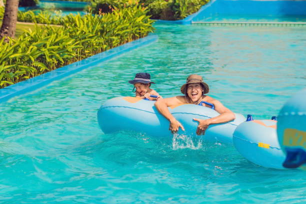istock Father and son have fun at the water park 1180695465